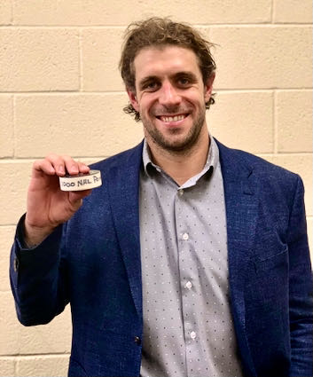 Los Angeles Kings center Anze Kopitar, shown here post-game, holding the puck from his 1,000th career NHL point, May 5, 2021 in Glendale, Arizona. Photo courtesy of the Los Angeles Kings